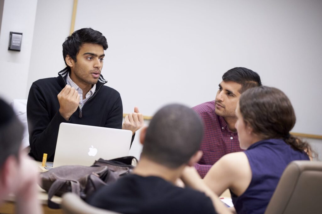 Group of students sitting down and having a discussion