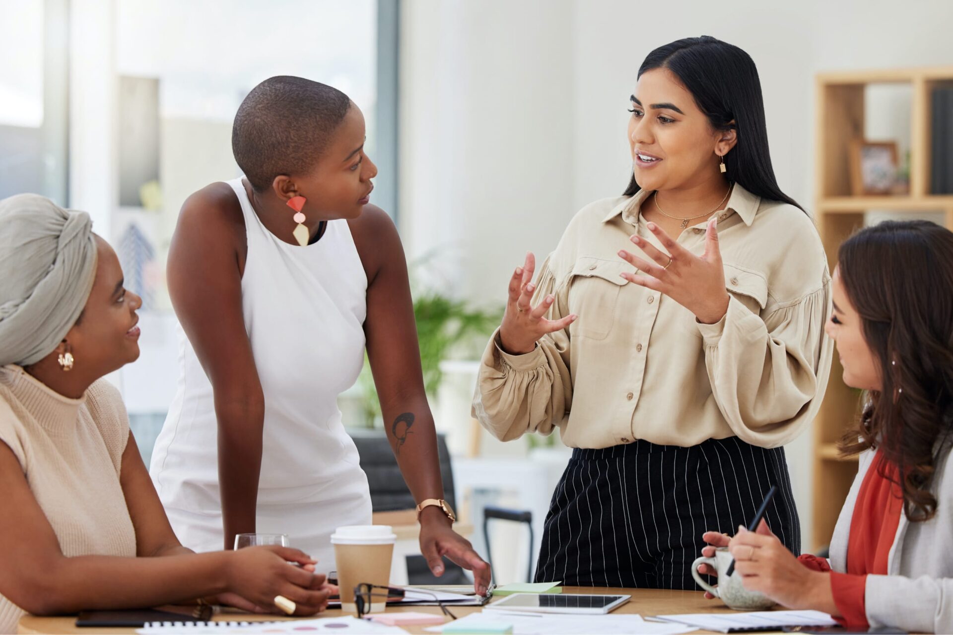 Women discussing a project at a table