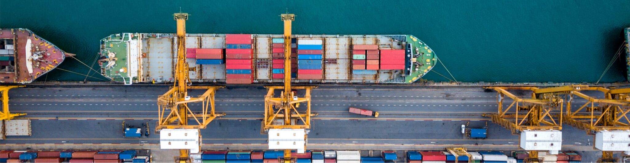 A cargo ship at dock viewed from above